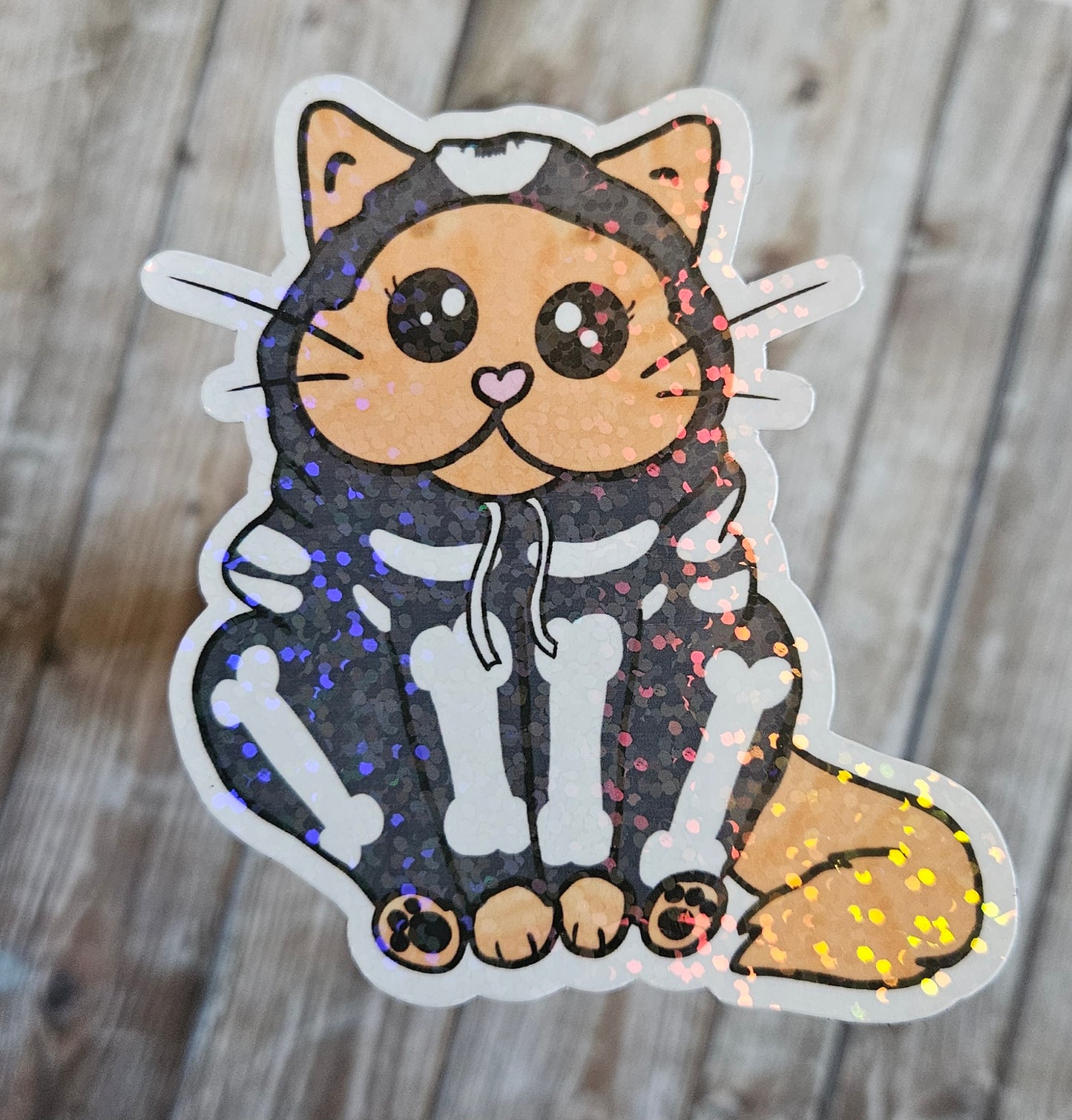 Chonky orange cat in a skeleton hoodie sticker for water bottle