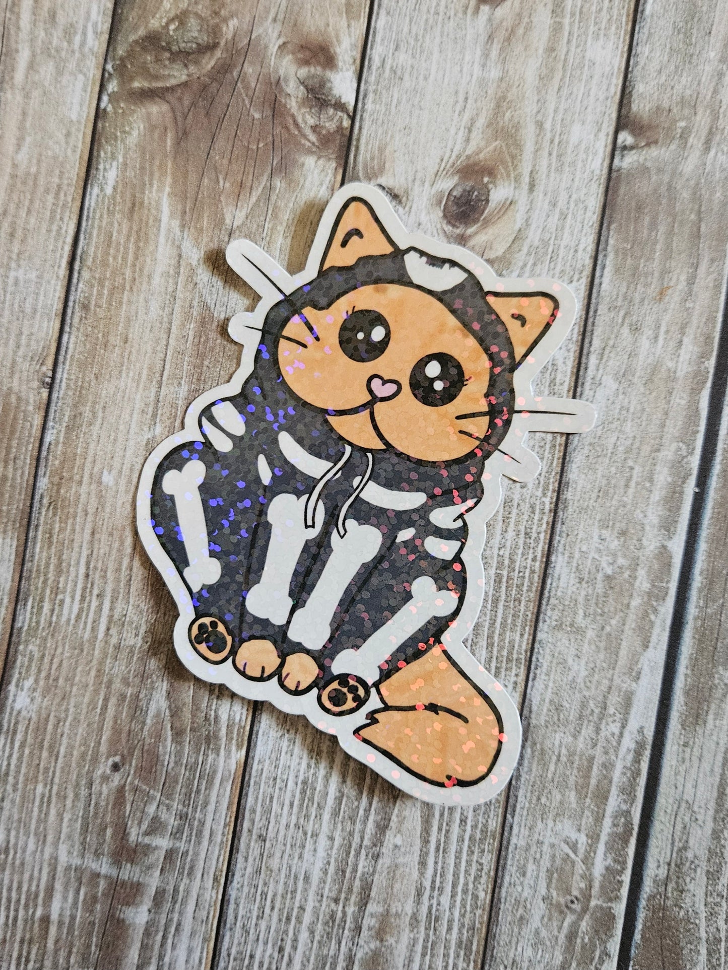 Chonky orange cat in a skeleton hoodie sticker for water bottle