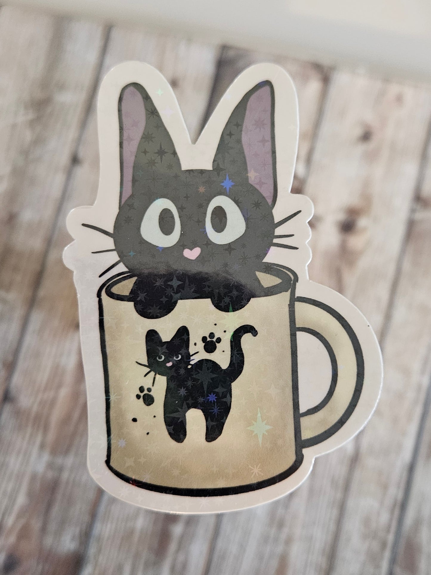 Black kitten in a cat mug sticker for laptop