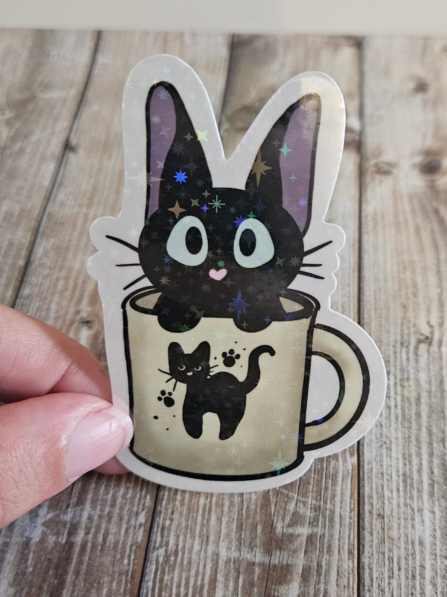 Black kitten in a cat mug sticker for laptop