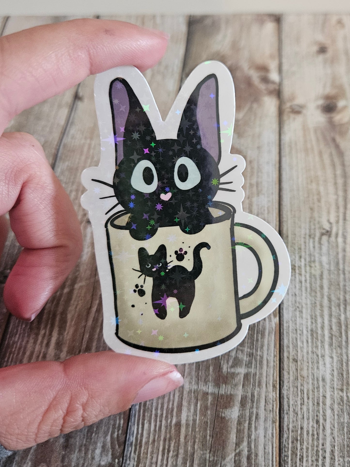 Black kitten in a cat mug sticker for laptop