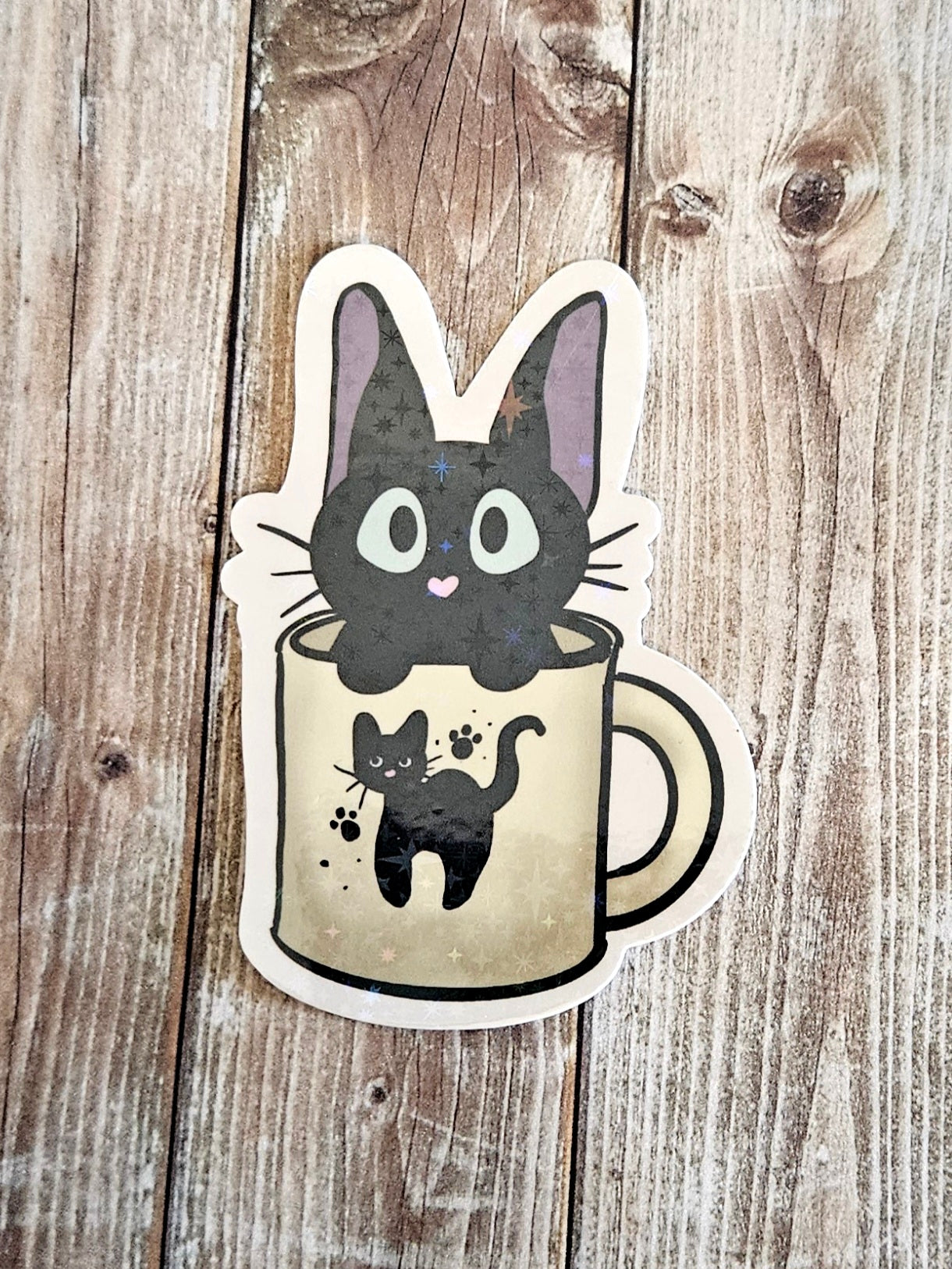 Black kitten in a cat mug sticker for laptop