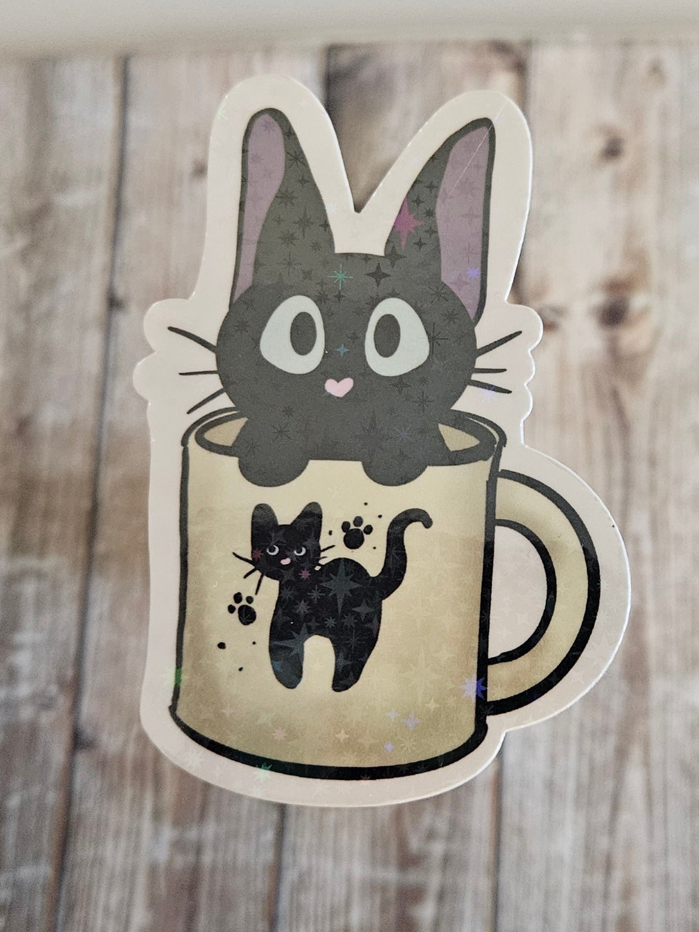 Black kitten in a cat mug sticker for laptop