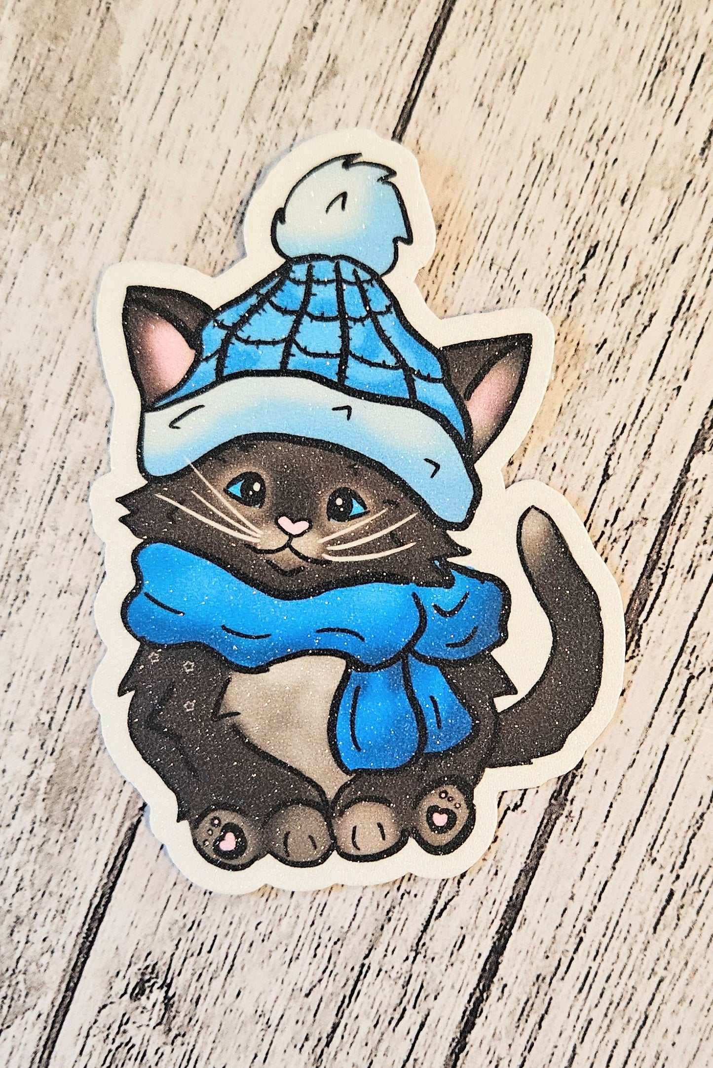 Black kitten with a blue hat and scarf sticker for water bottle