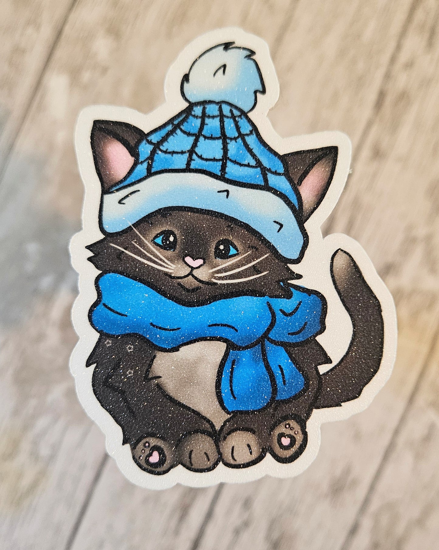 Black kitten with a blue hat and scarf sticker for water bottle