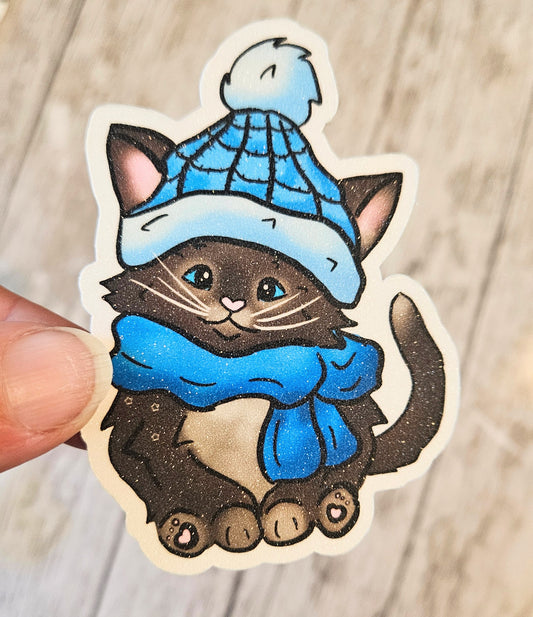 Black kitten with a blue hat and scarf sticker for water bottle